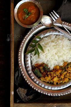 a silver plate topped with rice and meat