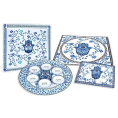 a blue and white plate with four plates on it, one has an ornate design