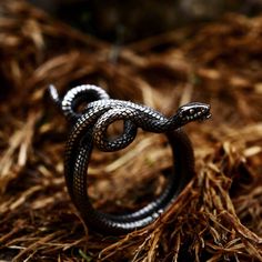 Snake rings or serpent rings have been popular throughout history and often represent eternal love.... Engraved Metal Snake-shaped Jewelry, Adjustable Engraved Snake Ring, Symbolic Engraved Adjustable Snake Ring, Symbolic Adjustable Engraved Snake Ring, Adjustable Symbolic Snake Ring, Adjustable Engraved Symbolic Snake Ring, Silver Symbolic Snake Shaped Ring, Spiritual Snake Ring As Gift, Spiritual Snake Ring For Gift