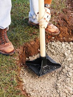 a man is digging in the ground with a shovel