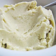 a white bowl filled with ice cream on top of a table