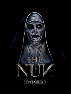 the nun movie poster with an evil face and head in black robes, on a dark background