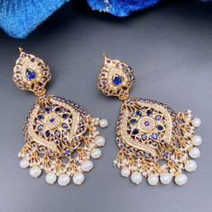 Featuring a pair of gold plated silver earrings. It has been embellished with precious freshwater pearls and sapphire look alike stones. The earrings have a bombay screw. ﻿All of Rudradhan's Gold Plated Jewellery is made using 925 Silver, real freshwater pearls and high quality ruby, emerald and sapphire beads. The default choice for studded stones used is synthetic that closely resemble original gemstones. Fusion Pearl Earrings With Meenakari For Celebrations, Fusion Style Pearl Earrings With Meenakari For Celebration, Fusion Style Meenakari Pearl Earrings For Celebrations, Elegant Pearl Meenakari Earrings For Diwali, Traditional Dangle Pearl Earrings For Anniversary, Gold Plated Hand Set Temple Jewelry Earrings, Traditional Yellow Gold Hallmarked Pearl Earrings, Formal Temple Jewelry Pearl Drop Earrings, Elegant Meenakari Pearl Earrings For Festivals