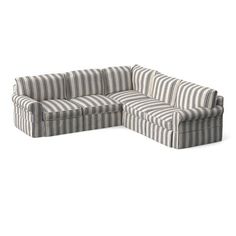 a striped sectional couch sitting on top of a white floor