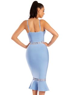 a woman in a light blue dress with cutouts on the sides and straps at the waist