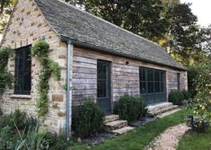 an old brick building with ivy growing on it's roof