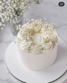 there is a white cake with flowers on it