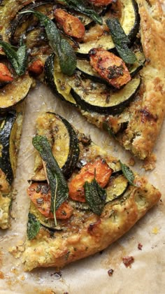 a pizza with zucchini, squash and spinach on it's side