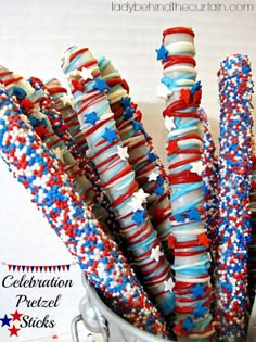 red, white and blue pretzel sticks are in a bucket with the words celebration pretzels