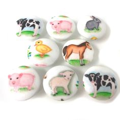 six buttons with farm animals on them sitting next to each other in front of a white background