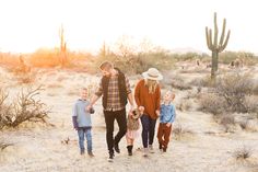 a family walking through the desert holding hands