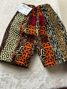 Unleash your summer style with our Moji Ankara shorts! Perfect for the beach, hikes, and beyond, they offer unbeatable comfort and undeniable style. Experience the ultimate blend of fashion and function. Get the best buy for your summer wardrobe now. Size and Fits: Please refer to the size guide in the gallery for best fit. Shorts has pockets on both sides. Elastic waist for comfort. Color may vary due to lighting of images. The images of models are closest to the true color of the fabric. Care Bohemian Bottoms With Built-in Shorts For Vacation, Orange Swim Trunks With Built-in Shorts For Beach, Kitenge Shorts For Ladies, Multicolor Swim Trunks With Elastic Waistband For Vacation, Beachwear Bottoms With Built-in Shorts For Festival, Cotton Bermuda Swim Trunks For Beach, Orange Short Swim Trunks With Built-in Shorts, Multicolor Vacation Shorts With Elastic Waistband, Orange Swim Trunks With Built-in Shorts