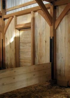 the inside of a barn with wooden walls