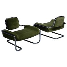 a pair of green chairs with chrome frames and footrests, one is upholstered