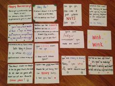 several pieces of paper with words and phrases on them sitting on a wooden table next to each other