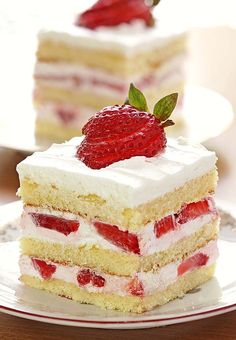 a piece of cake on a plate with strawberries