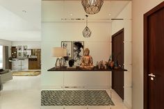 a buddha statue sitting on top of a table in a living room next to a doorway