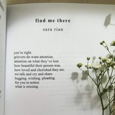 the book is open with flowers in it and some words written on the front page