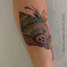 a lady bug tattoo on the left arm