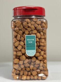 a jar filled with lots of brown dog food