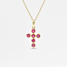 This gorgeous pendant is studded with rubies (glass filled) surrounded by 14k solid yellow gold. Ruby is said to be a powerful talisman for attracting good luck. It is thought to increase wealth, protect you from bad luck, and bring success in all your endeavours. Ruby is a July birthstone. It is a minimal yet classy holy cross pendant, making it a perfect gift for your loved ones! Product Details Material : 14K Solid Yellow Gold Gemstone : Ruby (glass filled) Gemstone size : 3 mm Pendant Width : 10 mm Pendant Height : 21 mm Item weight : 1 gram Please select the chain if required from the available options. Chains are available in many different sizes. Please contact us for customisation. Chain details Material: 14k solid yellow gold  Chain thickness: 0.5 mm Ruby Pendant In Yellow Gold, Yellow Gold Ruby Pendant Jewelry, Ruby Birthstone Pendant Necklace In Yellow Gold, Spiritual Ruby Jewelry In Yellow Gold, Yellow Gold Cross Pendant Necklace With Gemstone, Ruby Birthstone Pendant In Yellow Gold, Gold Ruby Necklaces With Bezel Setting, Spiritual Yellow Gold Ruby Jewelry, Yellow Gold Ruby Pendant Birthstone Necklace