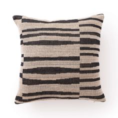 a black and white striped pillow sitting on top of a wall