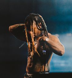 a man with dreadlocks standing on stage