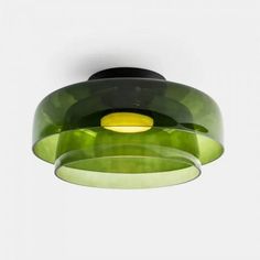 a green and black light hanging from the ceiling