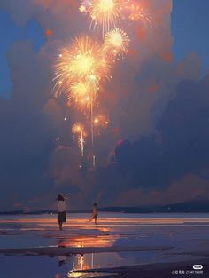 two people are standing on the beach watching fireworks