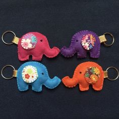 three small stuffed elephants are on key chains