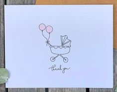 a thank you card with a baby carriage and balloons in the air, on top of a wooden table