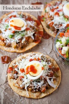 three pita breads topped with meat, cheese and veggies