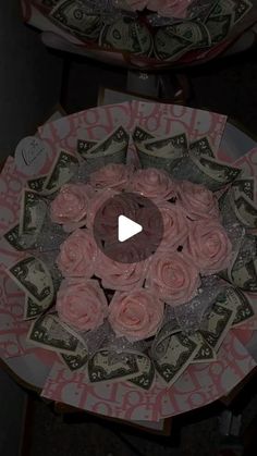 two roses sitting on top of each other with money in the background and an image of a dollar bill behind them