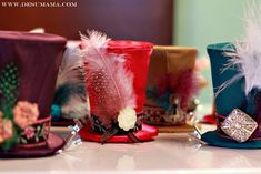 several hats with feathers and jewels on them are lined up in a row at the same time