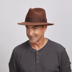 Adventure | Mens Felt Fedora Hat is crafted from lightweight felt wool, offering both durability and style. Its safari shape, 2 1/2” brim, and 1 1/4" grosgrain ribbon trim make it a versatile hat for both casual outings and polished ensembles. Material: Lightweight Felt Wool Shape: Safari Trim: 1 1/4" Width Grosgrain Ribbon Band Brim Size: 2 1/2” Crown Height: 4 1/8” Sweatband: AHM Velcro Imported Classic Brown Wool Fedora, Brown Wool Felt Hat With Flat Bill, Indiana Jones Style, Medium Length Brown Hair, Luis Guzman, American Hat Makers, Male Artists, Straw Fedora, Felt Wool