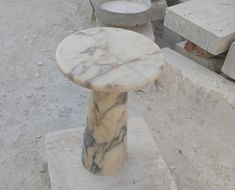 a marble pedestal sitting on top of cement blocks