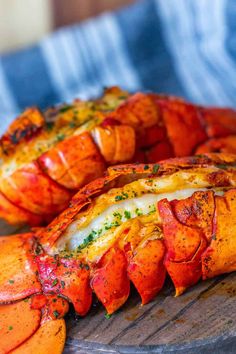 two cooked lobsters on a wooden platter