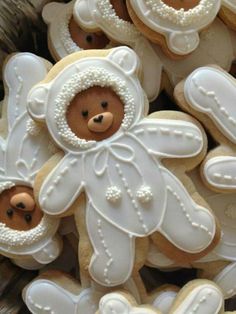 decorated cookies with teddy bears and snowflakes in the shape of babies'feet