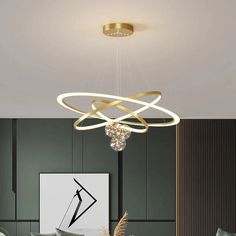 a modern chandelier hanging from the ceiling in a living room