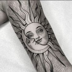 a sun and moon tattoo on the arm