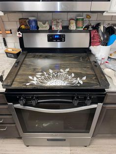 a stove top oven sitting inside of a kitchen