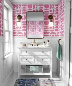 a bathroom with pink and white wallpaper, two sinks and a mirror on the wall