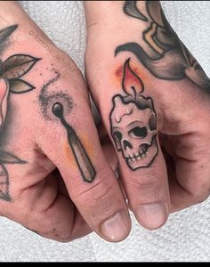 two hands with tattoos on their fingers and one has a skull in the middle, while the other holds a knife