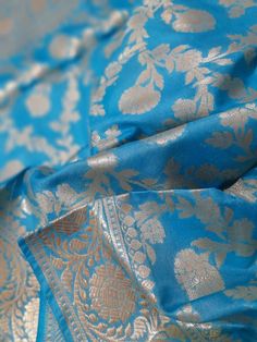 a blue and gold brocaded silk material