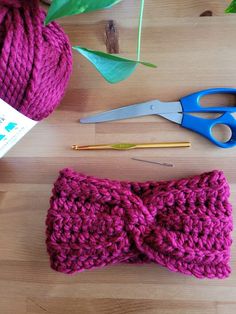 yarn, scissors and knitting needles on a table