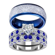 two wedding rings with blue and white stones on them, one has a heart shaped diamond in the center