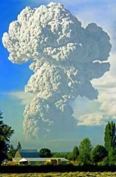 a large cloud is in the sky over a farm