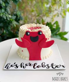 a red and white cake sitting on top of a table