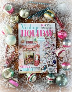 the cover of vintage holiday magazine surrounded by ornaments