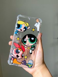 the powerpuff girls phone case is being held up by someone's hand